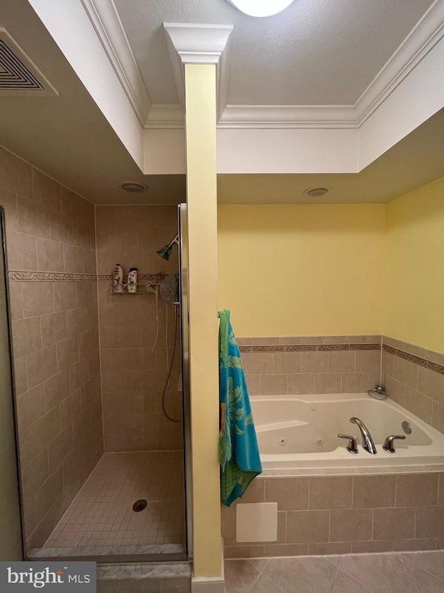 bathroom with tile patterned flooring, shower with separate bathtub, a textured ceiling, and ornamental molding