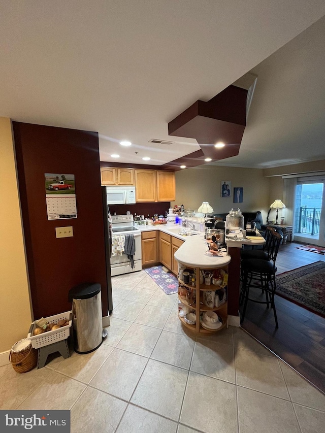 kitchen featuring white appliances and light tile patterned flooring