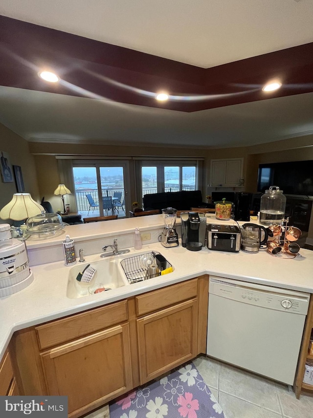 kitchen with dishwasher, light tile patterned floors, and sink