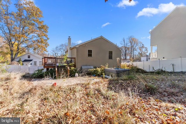 rear view of house featuring a deck