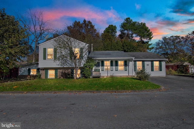 split level home with a yard