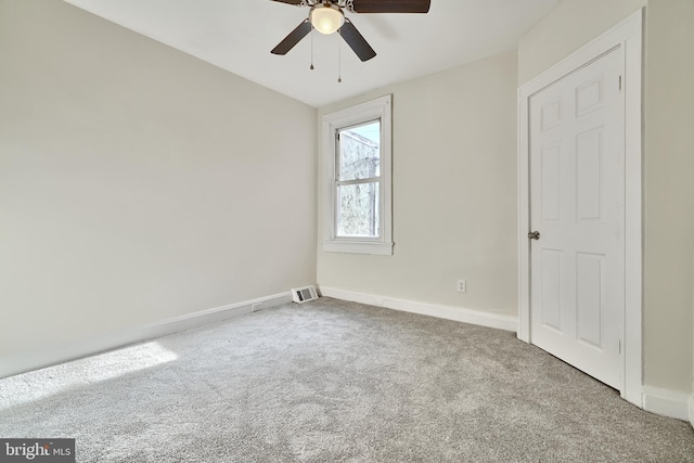 spare room featuring ceiling fan and light colored carpet