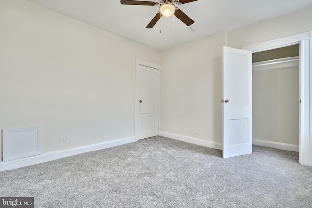 unfurnished bedroom featuring ceiling fan, a closet, and light colored carpet