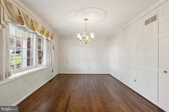 unfurnished dining area with a chandelier, crown molding, and dark wood-type flooring