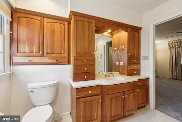 bathroom featuring tile patterned flooring, vanity, and toilet