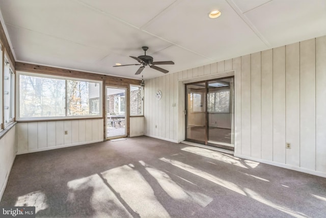 unfurnished sunroom featuring ceiling fan