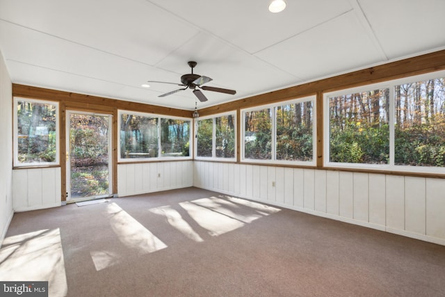 unfurnished sunroom with ceiling fan