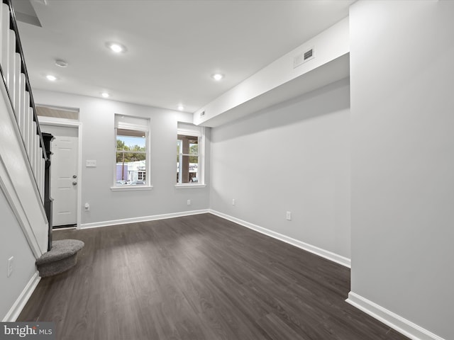 empty room with dark hardwood / wood-style flooring