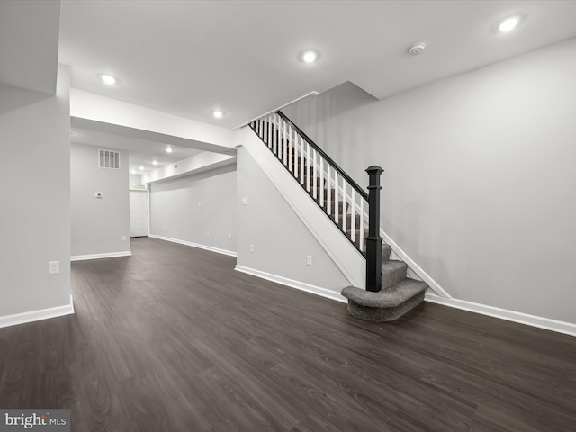 unfurnished living room with dark wood-type flooring