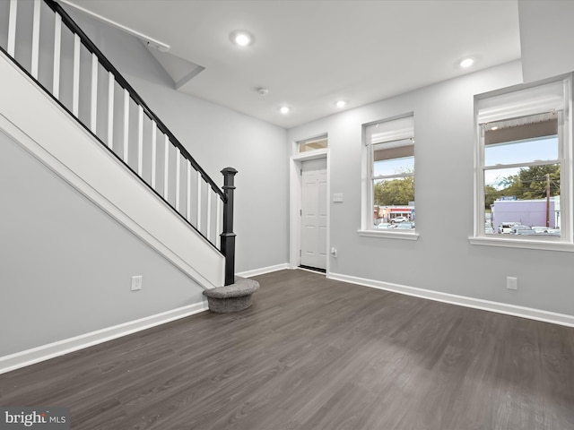 entrance foyer featuring dark hardwood / wood-style floors and a wealth of natural light