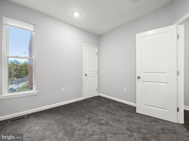 carpeted spare room with plenty of natural light