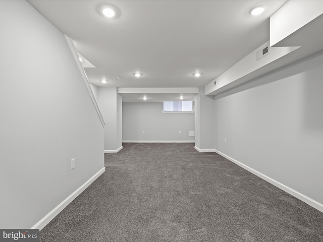 basement featuring dark colored carpet