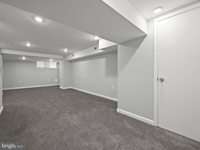 basement with dark colored carpet