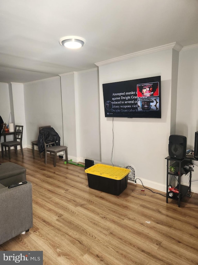 living room featuring hardwood / wood-style flooring and crown molding