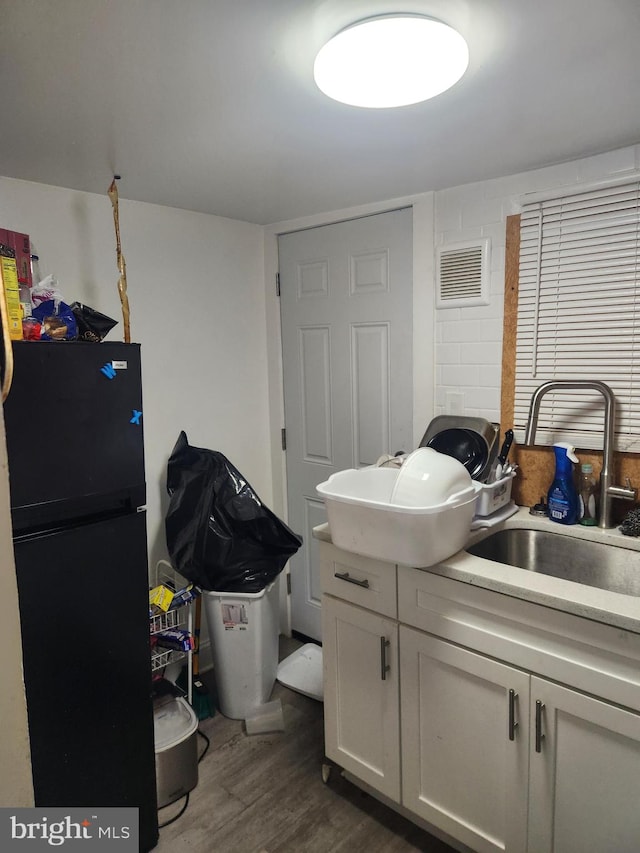 laundry room featuring dark hardwood / wood-style floors and sink