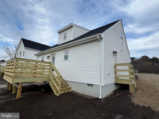 view of side of property featuring a deck