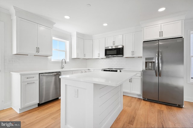 kitchen with appliances with stainless steel finishes and white cabinets