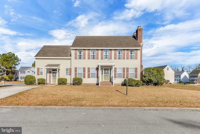 1119 Granbys Run, Salisbury, MD 21804 - colonial home featuring a chimney, a front yard, driveway, and roof with shingles