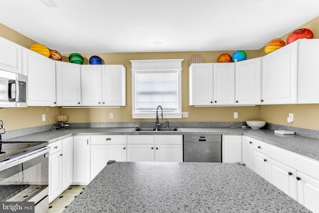 kitchen with appliances with stainless steel finishes, white cabinetry, and sink