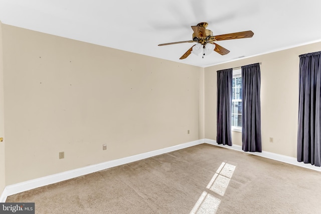 carpeted empty room featuring ceiling fan