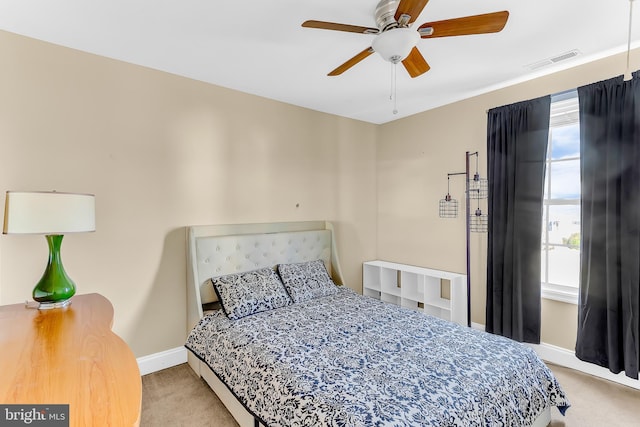 bedroom featuring ceiling fan and light colored carpet