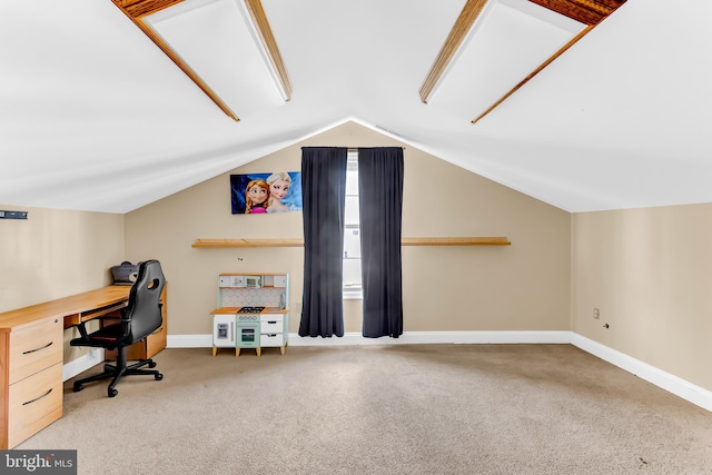 carpeted home office with lofted ceiling