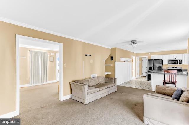 carpeted living room featuring ceiling fan and ornamental molding