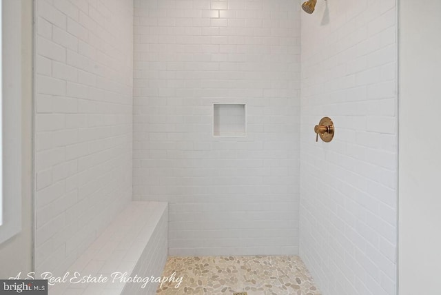 bathroom with tiled shower