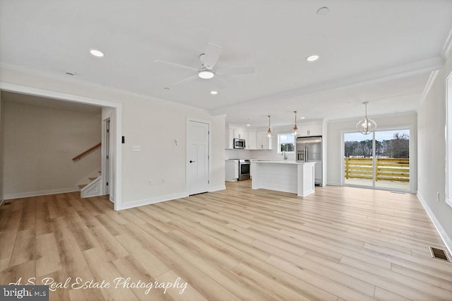 unfurnished living room featuring crown molding, light hardwood / wood-style flooring, and ceiling fan