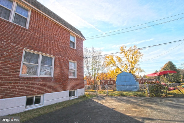 view of home's exterior with a shed