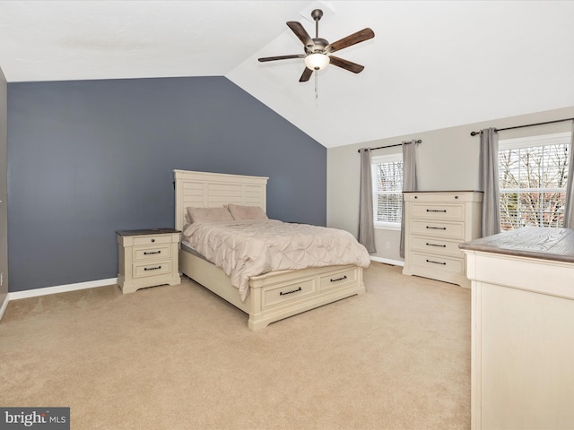 bedroom with multiple windows, ceiling fan, light colored carpet, and vaulted ceiling