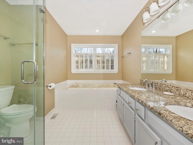 full bathroom featuring tile patterned floors, plenty of natural light, vanity, and toilet