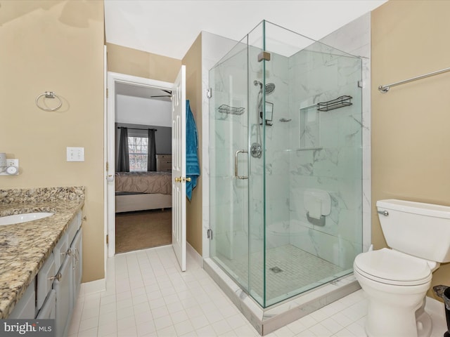 bathroom featuring toilet, vanity, tile patterned floors, and an enclosed shower