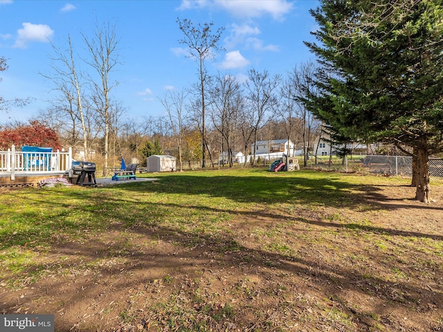 view of yard featuring a shed and a playground