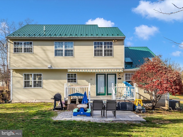 back of property with a patio area and a yard