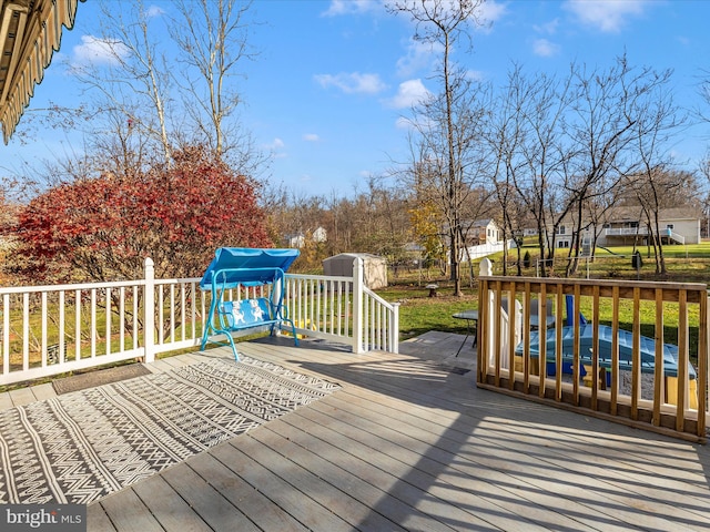 deck with a water view and a storage shed