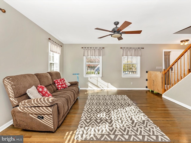 living room featuring wood-type flooring and ceiling fan