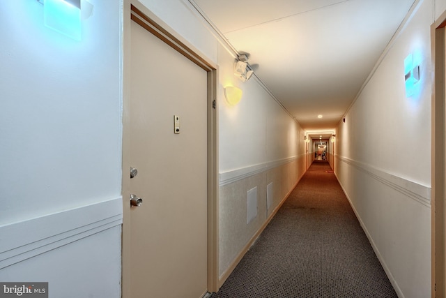 hallway featuring carpet flooring and ornamental molding