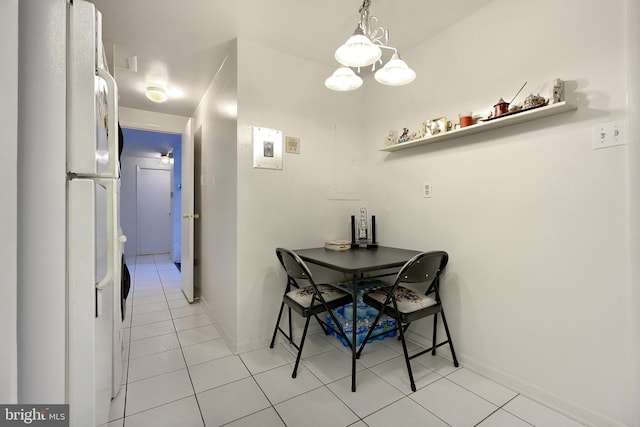 dining space with light tile patterned floors and an inviting chandelier