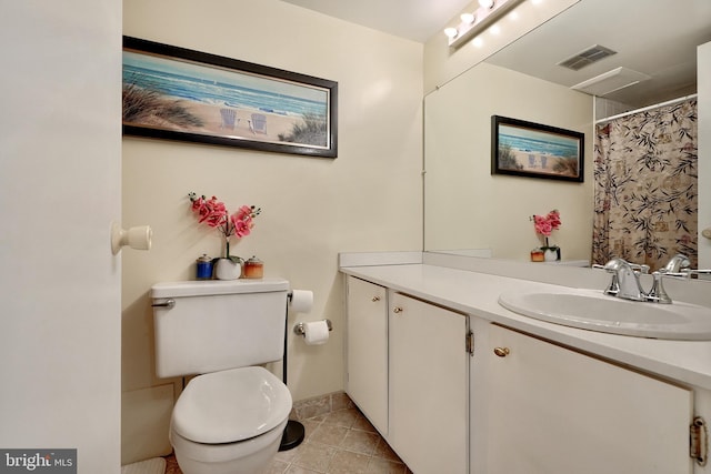 bathroom with tile patterned floors, vanity, and toilet