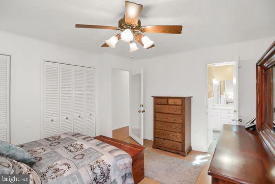 bedroom featuring ceiling fan and connected bathroom