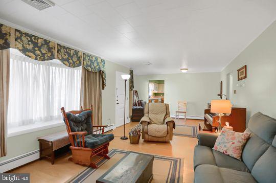 living room featuring wood-type flooring and a baseboard radiator