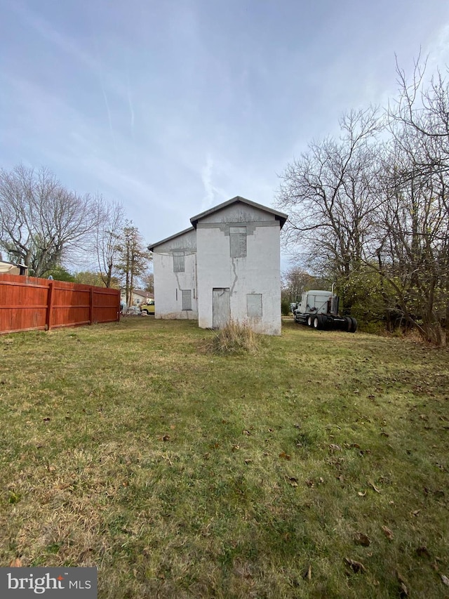 back of property featuring a lawn