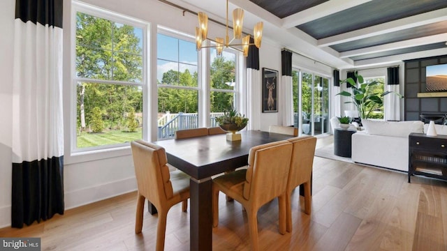 dining space with beamed ceiling, light hardwood / wood-style floors, and a notable chandelier