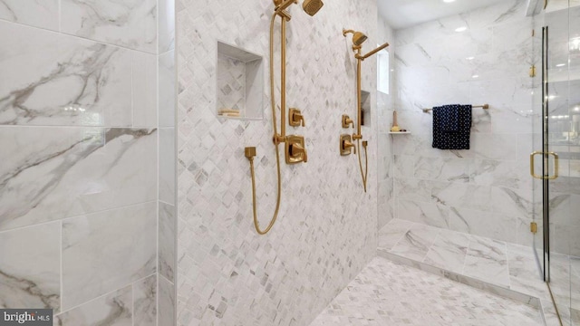 bathroom with a shower with shower door