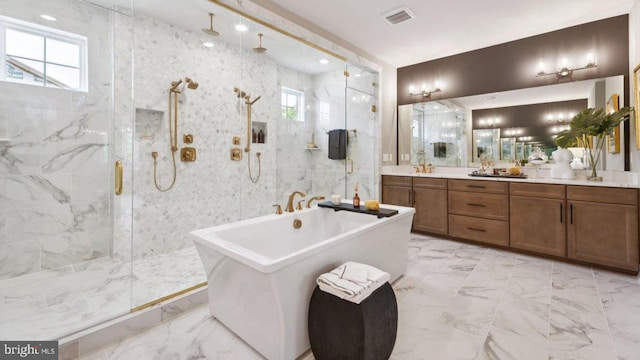 bathroom featuring vanity, a wealth of natural light, and separate shower and tub