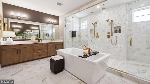 bathroom with vanity, plenty of natural light, and separate shower and tub