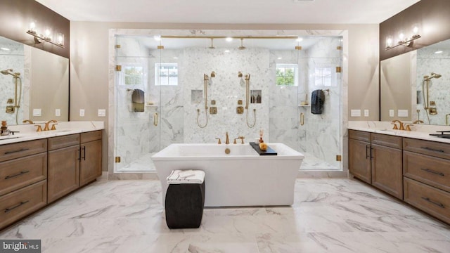 bathroom featuring vanity and independent shower and bath