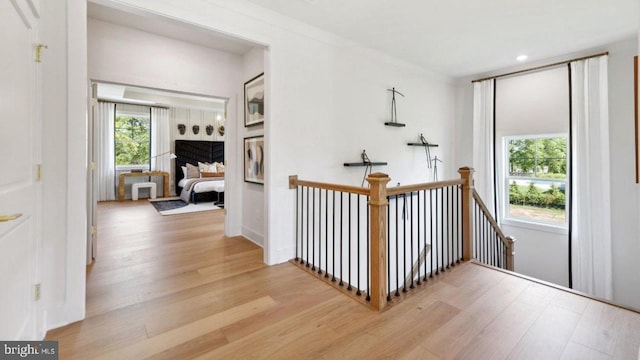 hallway with light hardwood / wood-style floors