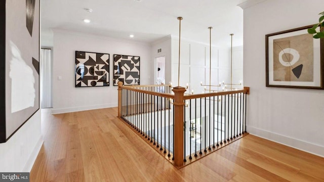 corridor featuring crown molding and hardwood / wood-style floors